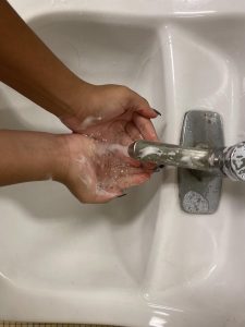 Washing hands to avoid germs and getting sick.