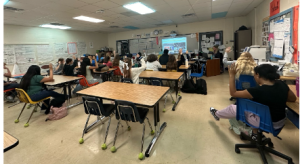 Students raise their hands to indicate that they were planning to buy a ticket.