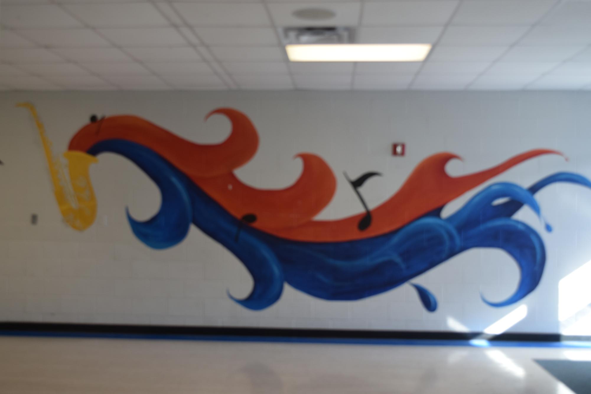 This painting of music notes is located on the wall by the auditorium.